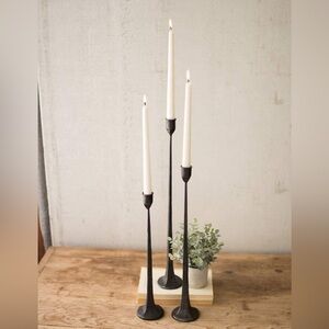 Set of 3 cast iron tapered candle holders.
